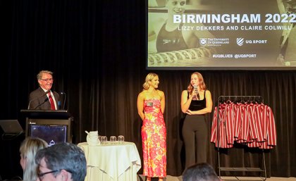 Two women standing on a stage at an awards event